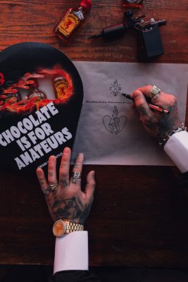 Overhead view of Fireball Chocolate is for Amateurs heart and JonBoy x Fireball tattoos