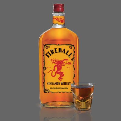 Download Fireball bottle with full shot glass on gray background