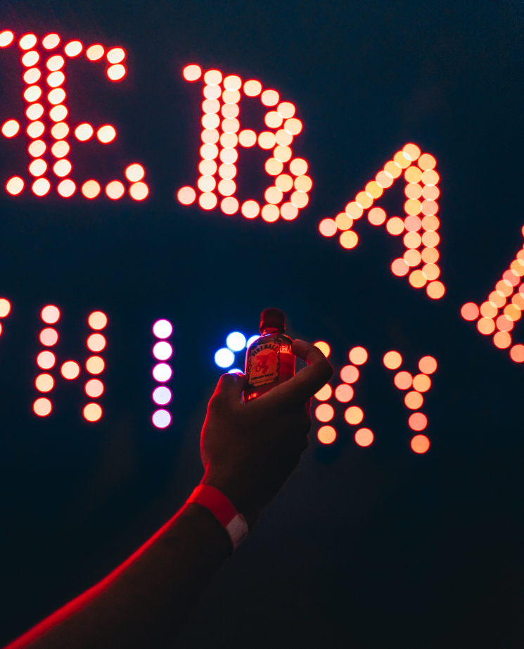 Fireball Logo in drones with hand holding a 50ml