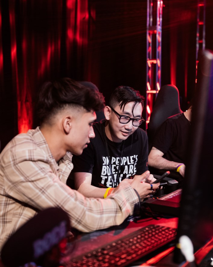Gamers sitting at gaming stations